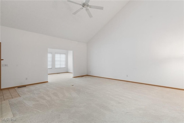 spare room featuring light colored carpet, high vaulted ceiling, and ceiling fan