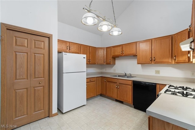 kitchen with sink, white refrigerator, high vaulted ceiling, black dishwasher, and hanging light fixtures