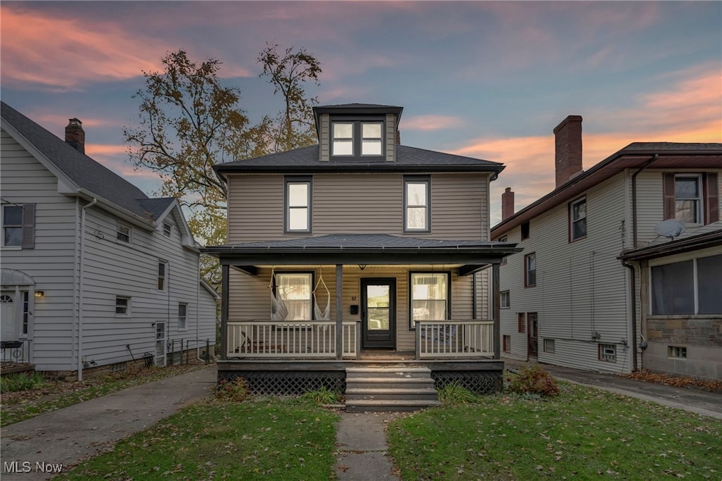 view of front of house featuring a yard and a porch