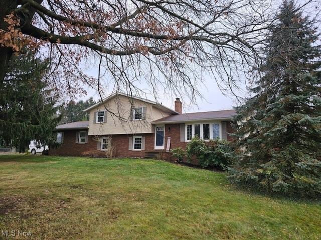 tri-level home with a front yard