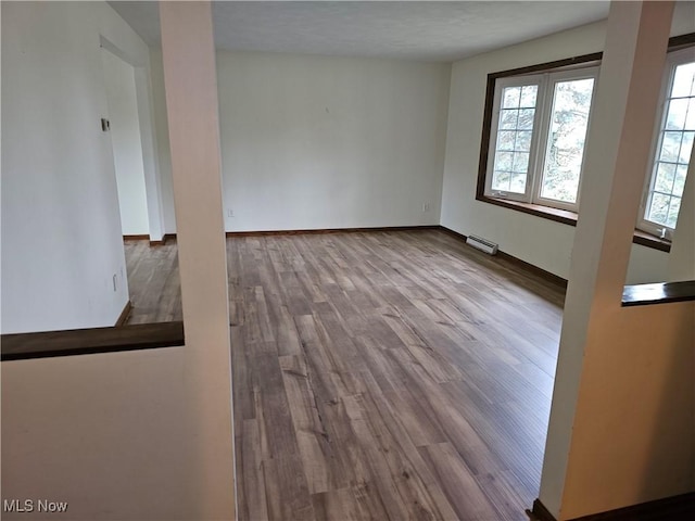 empty room featuring a textured ceiling and light hardwood / wood-style flooring