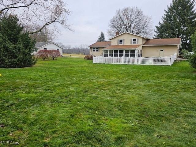 view of yard with a sunroom