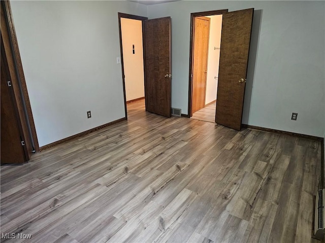 unfurnished bedroom featuring light hardwood / wood-style flooring