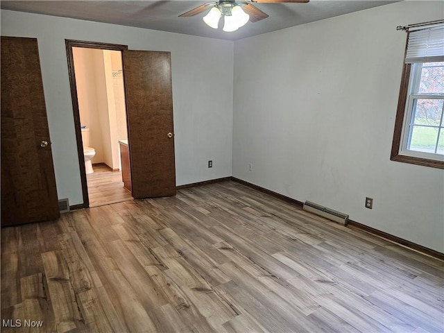 unfurnished bedroom with light hardwood / wood-style floors, ensuite bath, and ceiling fan