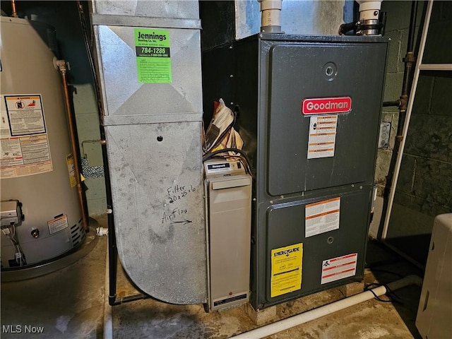 utility room with heating unit and gas water heater