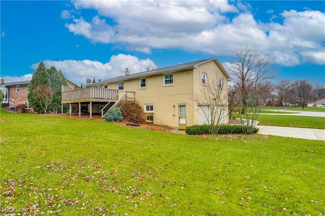 back of property with a yard and a wooden deck