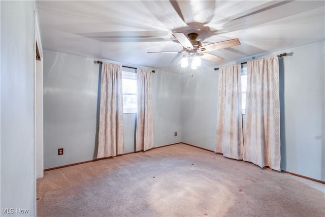 carpeted spare room with ceiling fan