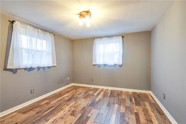 unfurnished room featuring hardwood / wood-style floors and a wealth of natural light