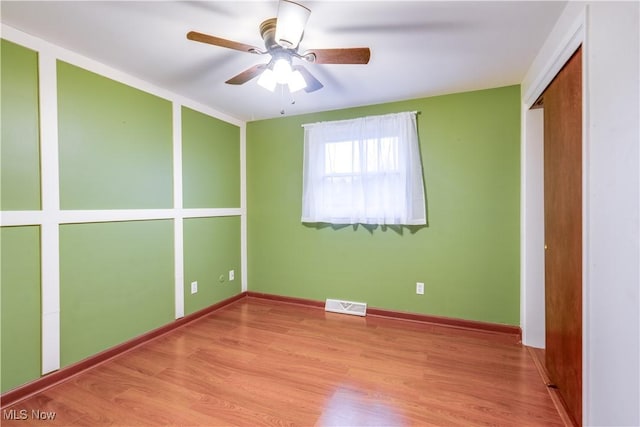 unfurnished bedroom with ceiling fan and light wood-type flooring