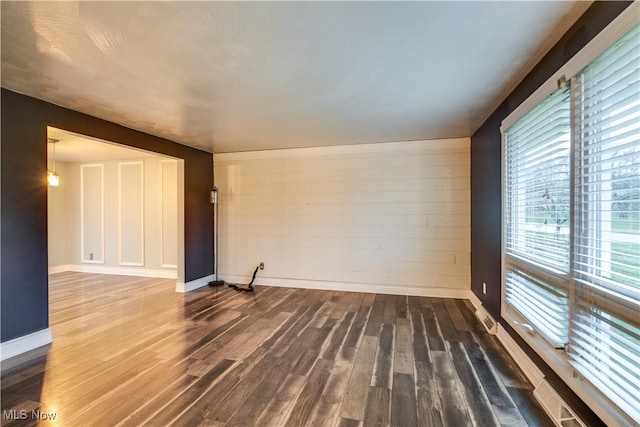 unfurnished room featuring dark hardwood / wood-style flooring