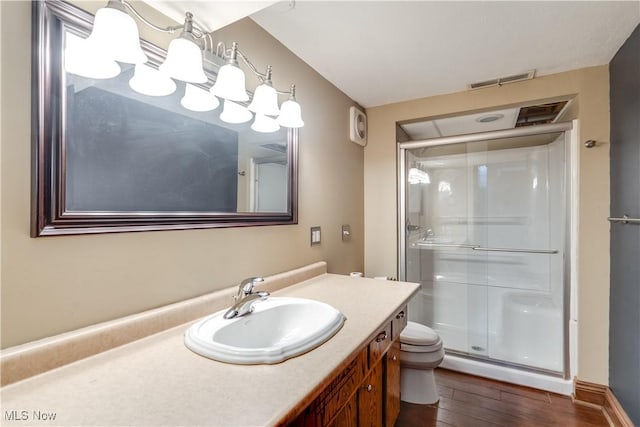 bathroom with toilet, a shower with door, vanity, and hardwood / wood-style floors