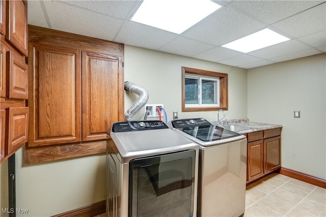 laundry area featuring sink, separate washer and dryer, and cabinets