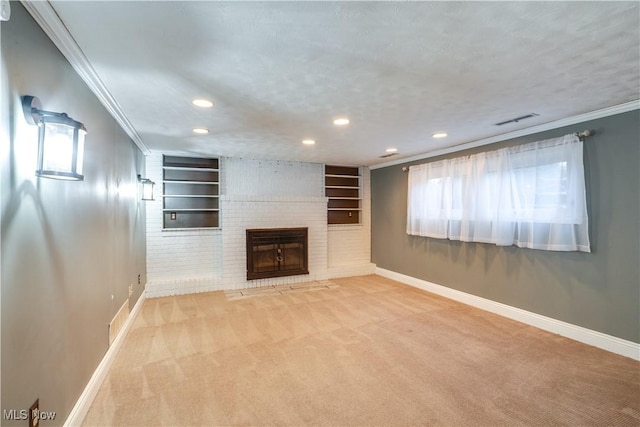 unfurnished living room with carpet flooring, a fireplace, a textured ceiling, built in features, and crown molding