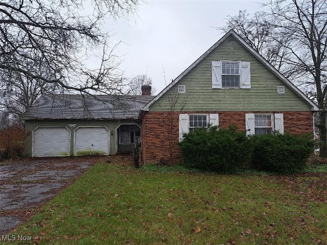 view of front of home with a front lawn and a garage