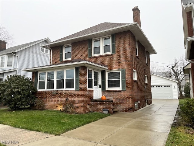 view of front of home featuring a front yard, an outdoor structure, and a garage