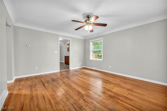 unfurnished room with hardwood / wood-style floors, ceiling fan, and ornamental molding