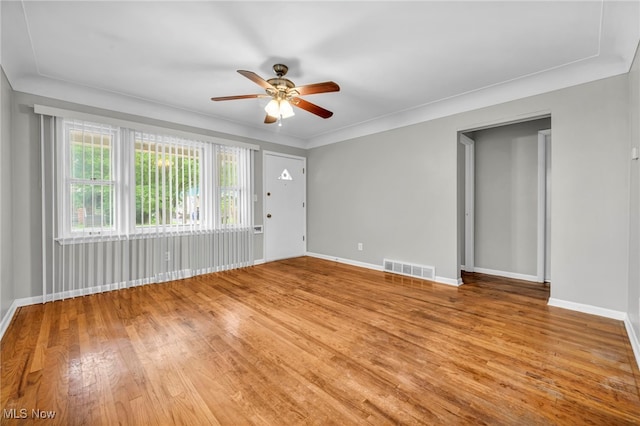 empty room with ceiling fan, light hardwood / wood-style floors, and crown molding