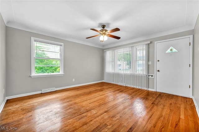 entryway with wood-type flooring and ceiling fan