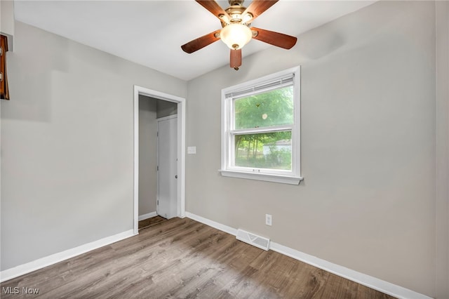 unfurnished bedroom with ceiling fan, light hardwood / wood-style floors, and a closet