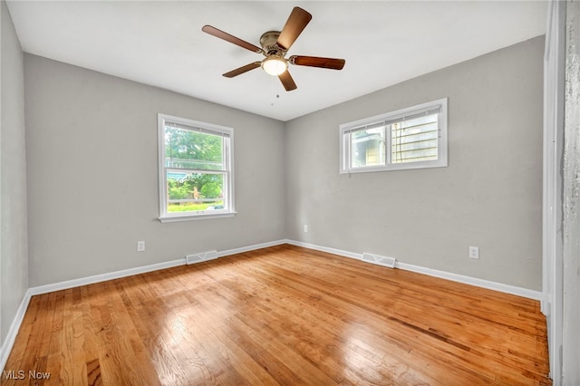 spare room with hardwood / wood-style flooring and ceiling fan