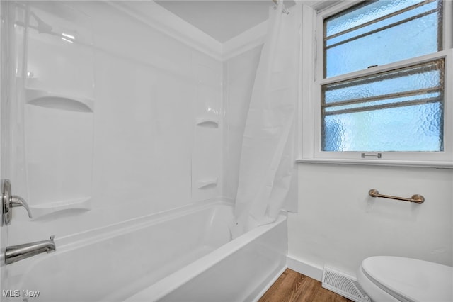 bathroom with toilet, shower / bath combination with curtain, and hardwood / wood-style flooring