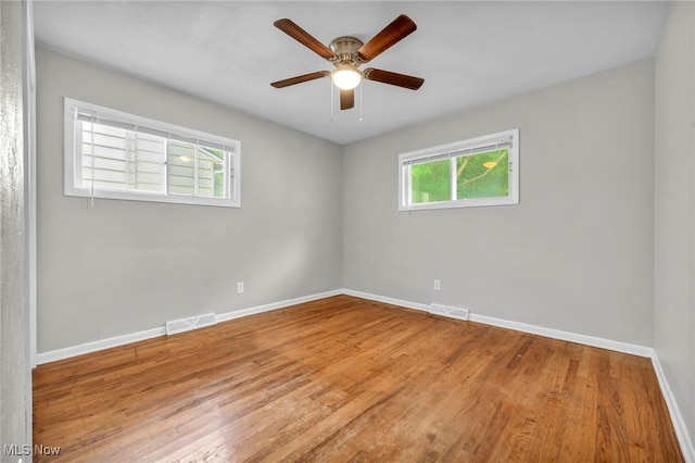 empty room with wood-type flooring and ceiling fan