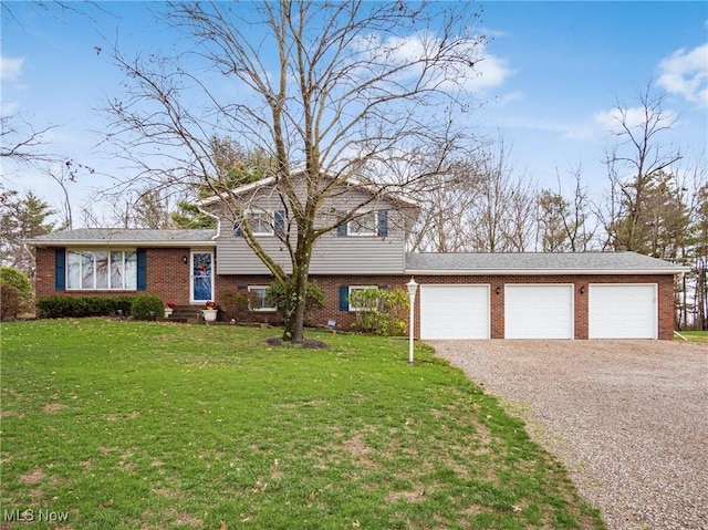 tri-level home featuring a garage and a front yard