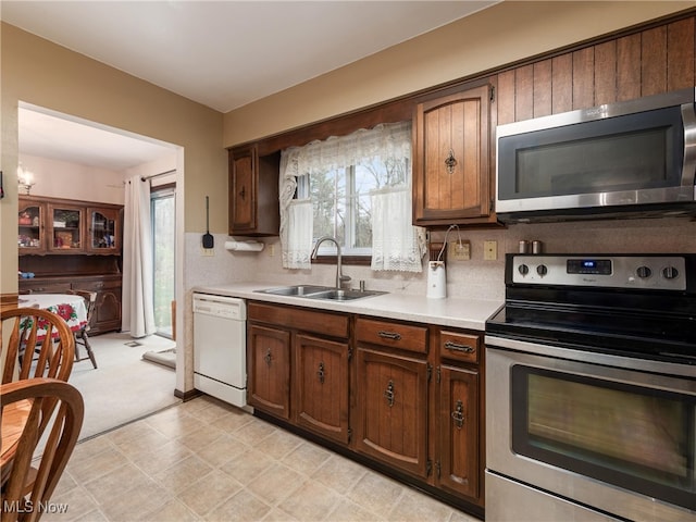 kitchen featuring sink, appliances with stainless steel finishes, and tasteful backsplash