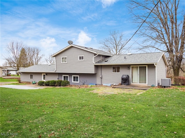 back of property featuring a yard, a patio, and central AC unit