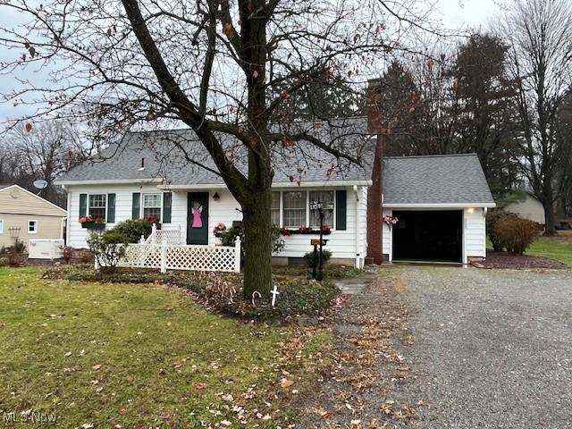 ranch-style home with a garage and a front lawn