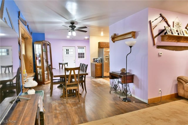 dining space with ceiling fan and wood-type flooring