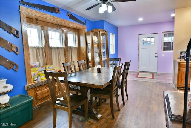 dining space featuring ceiling fan and dark wood-type flooring