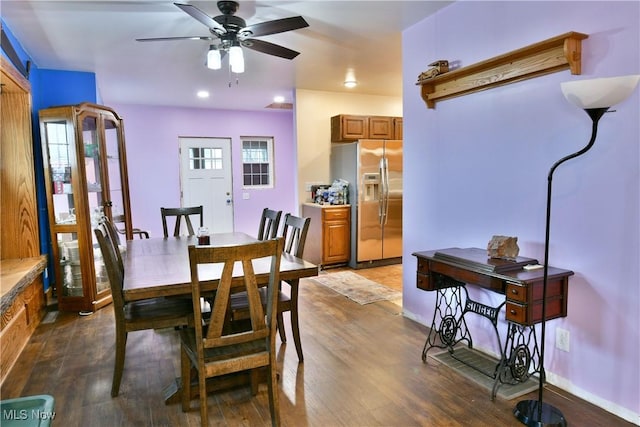 dining room with ceiling fan and dark hardwood / wood-style flooring