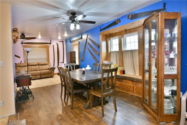 dining room featuring ceiling fan and dark wood-type flooring