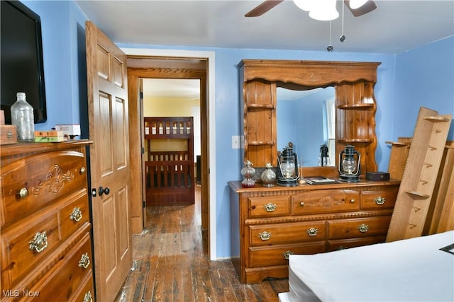 bedroom with dark hardwood / wood-style flooring