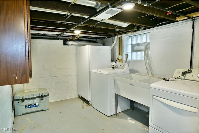 clothes washing area with sink and washing machine and clothes dryer