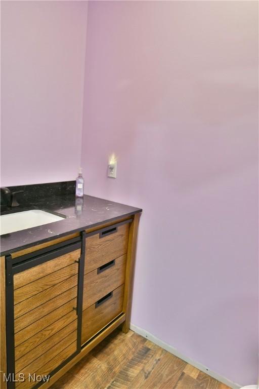 bathroom with wood-type flooring and vanity