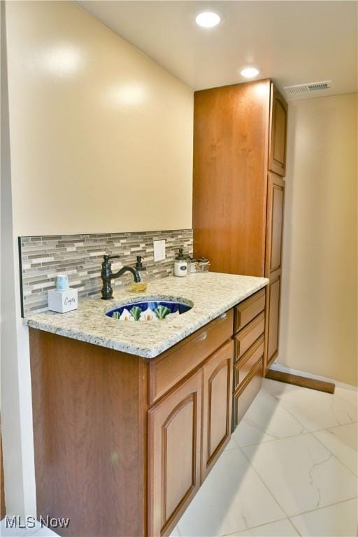 bathroom with vanity and backsplash