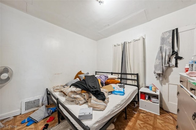 bedroom with light parquet floors