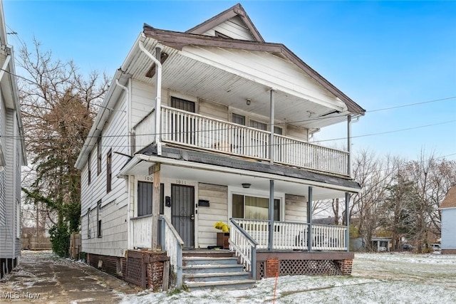 view of front facade with covered porch and a balcony