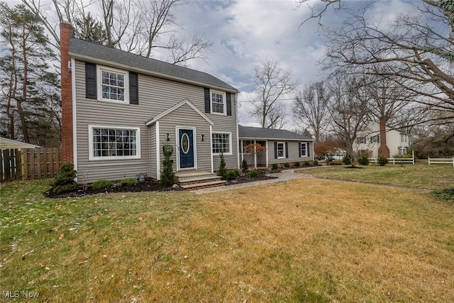 colonial inspired home featuring a front yard