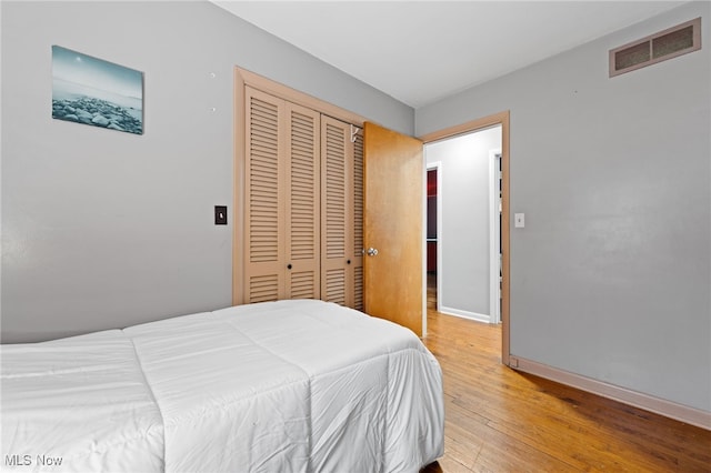 bedroom featuring hardwood / wood-style flooring and a closet