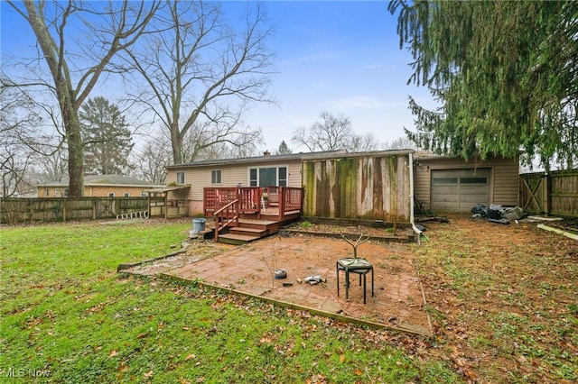 rear view of house with a yard and a wooden deck