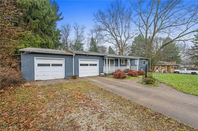 single story home with covered porch, a garage, and a front lawn