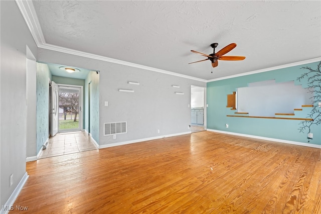 spare room featuring ceiling fan, light hardwood / wood-style floors, and a textured ceiling