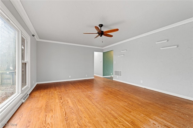 unfurnished room featuring ceiling fan, light hardwood / wood-style floors, ornamental molding, and a baseboard radiator