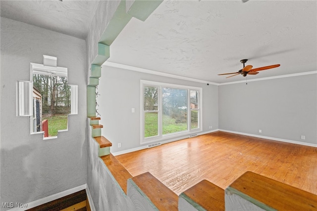 living room with ceiling fan, wood-type flooring, and ornamental molding