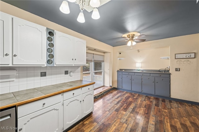 kitchen featuring white cabinets, tile counters, dark hardwood / wood-style floors, and backsplash