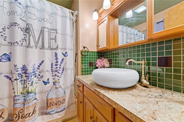 bathroom featuring vanity, a shower with curtain, and backsplash