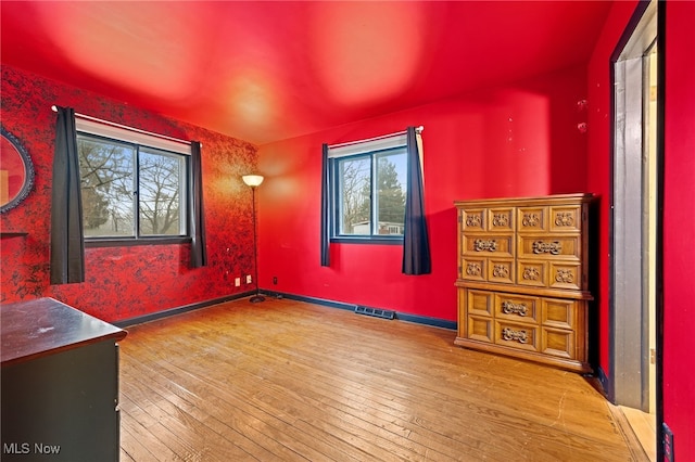 unfurnished room with wood-type flooring